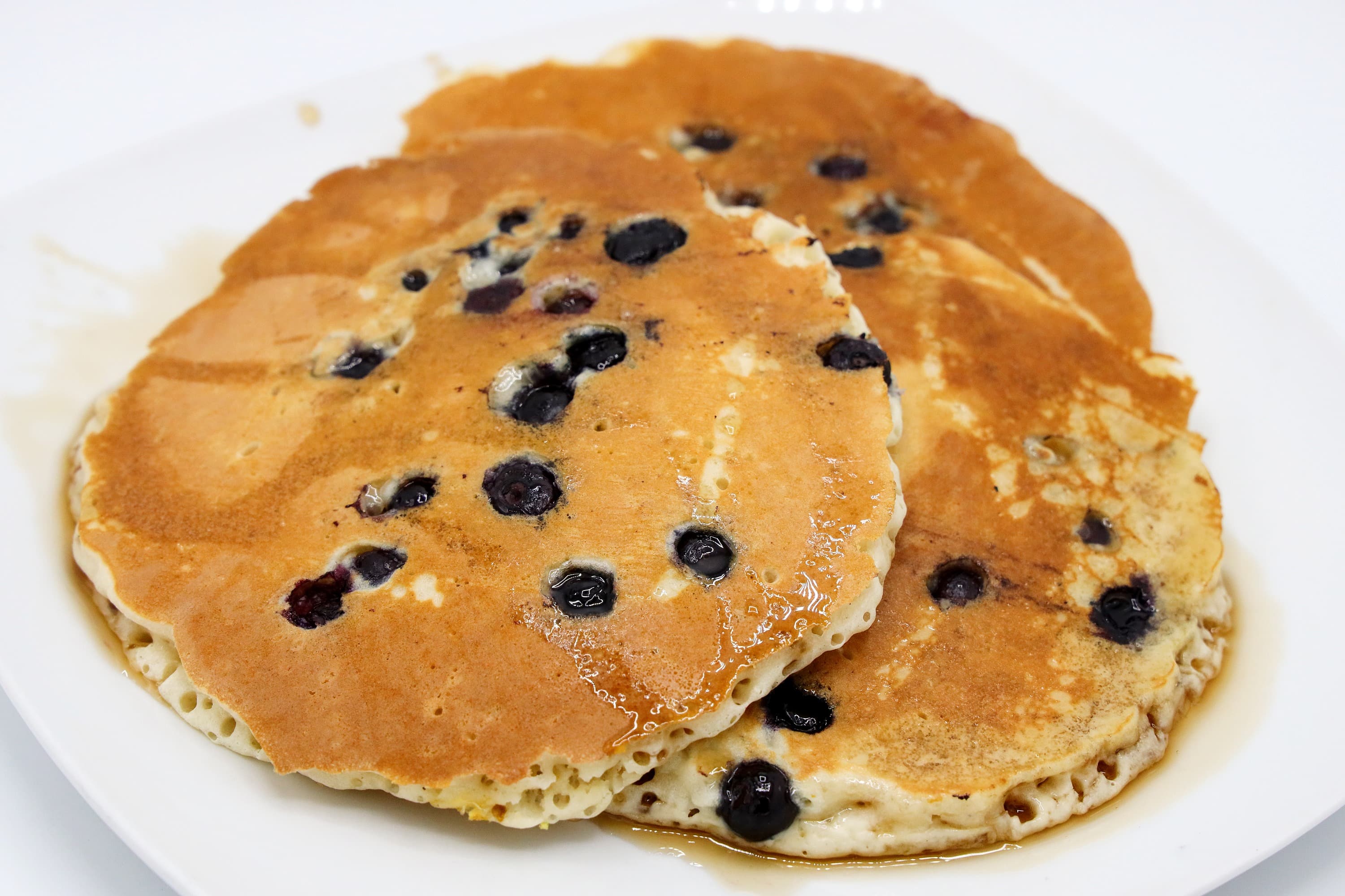 Stack of blueberry pancakes with syrup